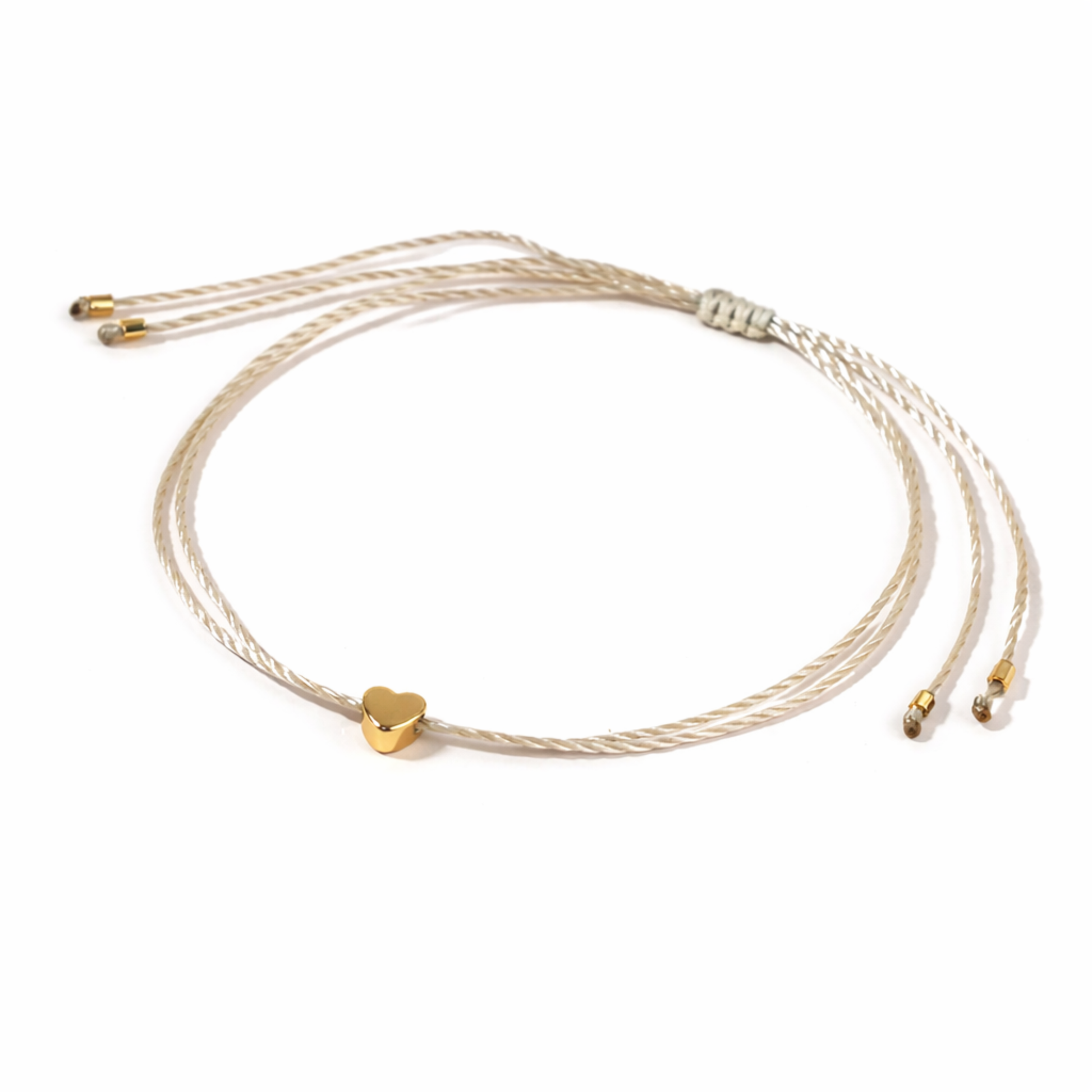 Gold bracelet with a heart charm on a white background